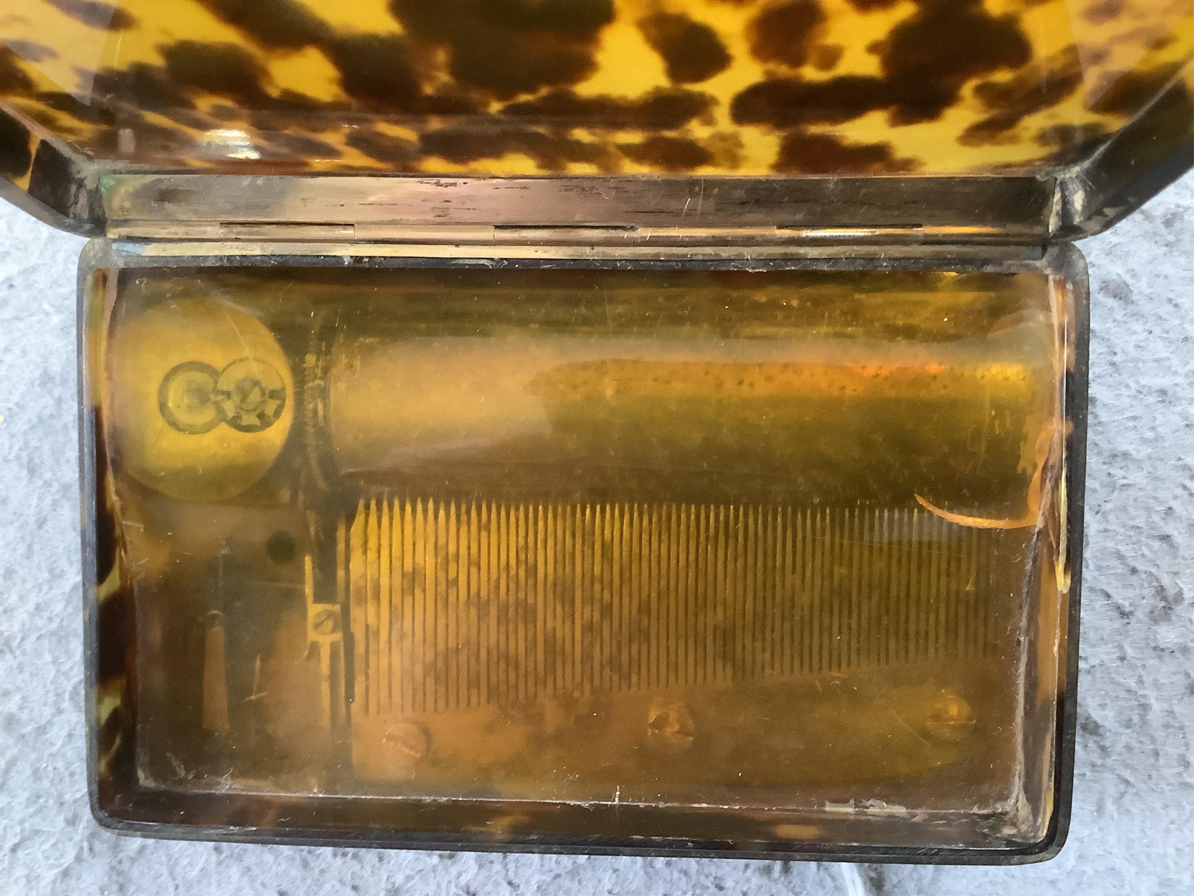 A 19th century tortoiseshell cased musical snuff box, 10cm. Condition - fair